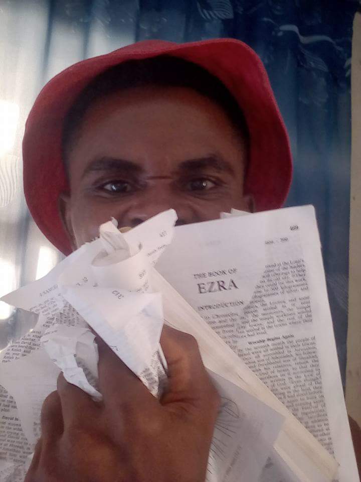  Man Tears Copy Of The Bible After A Catholic Priest Destroyed A Shrine In His Community In Anambra