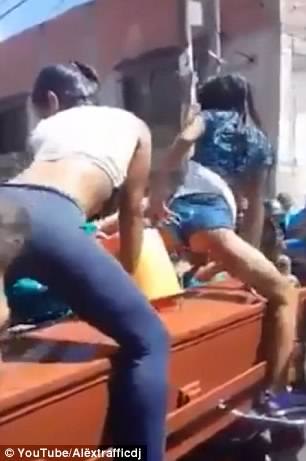 Two Women Have Sparked Outrage After They Were Filmed Twerking In Wet T-shirts Over Their Friend's Coffin 