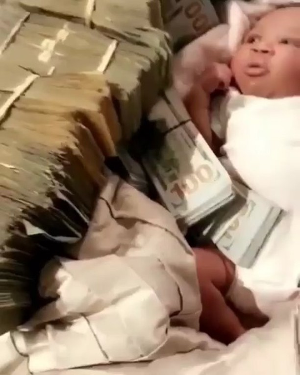 Rick Ross Surrounds Newborn Daughter With Cash (2)