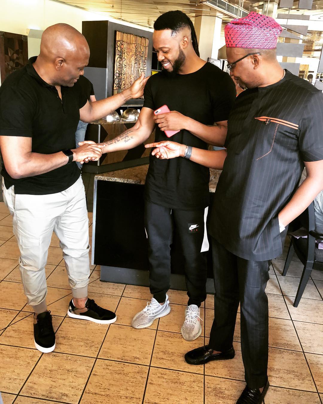 Tony Elumelu Pictured Checking Out Flavour’s Tattoos (2)